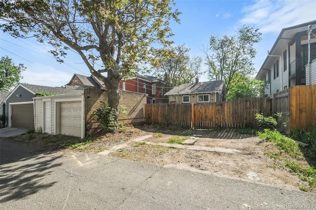 1633 Gaylord St, Denver, CO 80206 - view of side of home featuring fence and a garage
