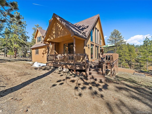 view of property exterior with a wooden deck