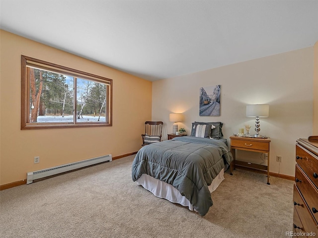 bedroom with baseboard heating, light colored carpet, and baseboards