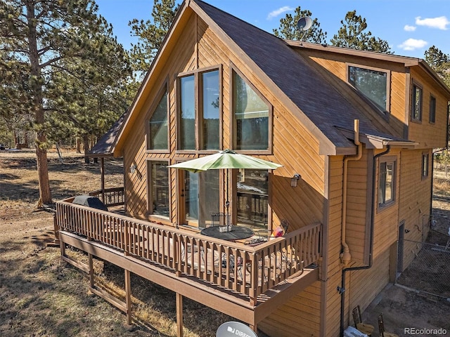 rear view of house featuring a deck