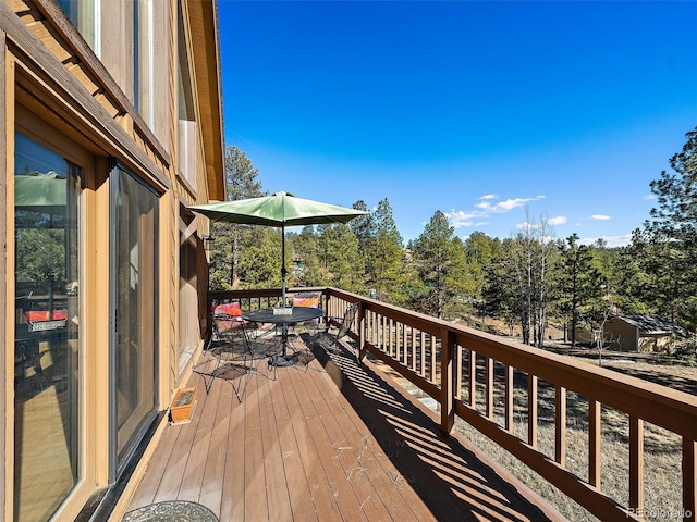 wooden terrace with outdoor dining space