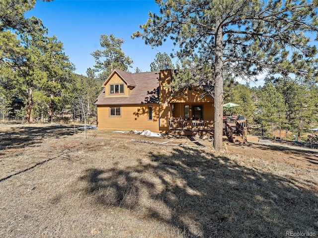 rear view of house featuring a chimney