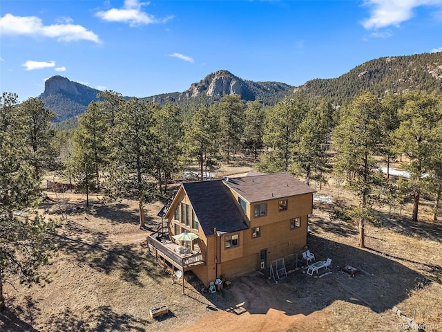 drone / aerial view featuring a mountain view and a wooded view