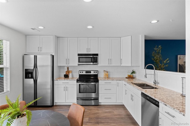 11845 W Tulane Dr, Morrison, CO 80465 - kitchen featuring stainless steel appliances, white cabinets, backsplash, light stone countertops, and dark wood-type flooring