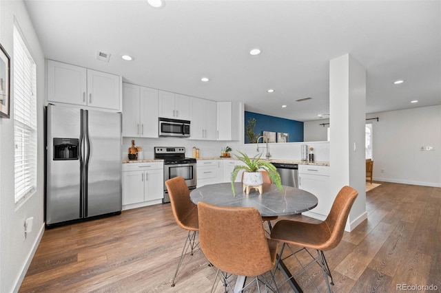 11845 W Tulane Dr, Morrison, CO 80465 - dining space featuring light wood-type flooring and recessed lighting