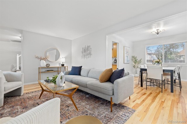 living room with baseboards and light wood finished floors