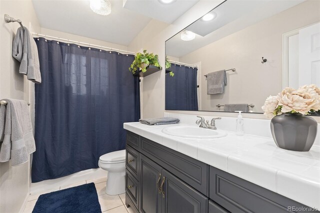 bathroom featuring vanity, tile patterned flooring, toilet, and curtained shower