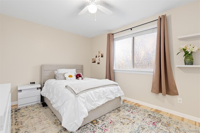 bedroom featuring baseboards, ceiling fan, and wood finished floors