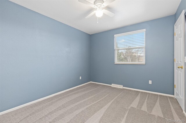 unfurnished room with baseboards, a ceiling fan, carpet flooring, and visible vents