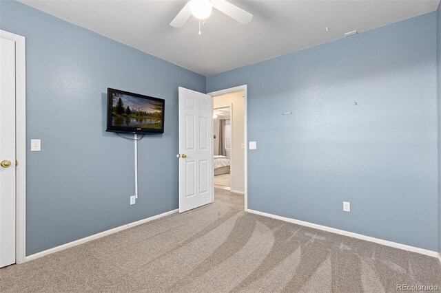 interior space featuring baseboards and a ceiling fan