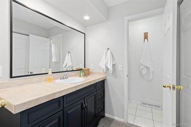 bathroom featuring visible vents, recessed lighting, baseboards, and vanity