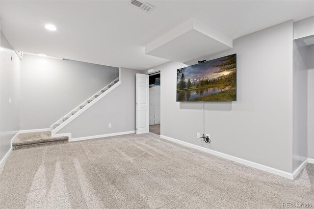finished basement featuring stairway, baseboards, carpet, and visible vents
