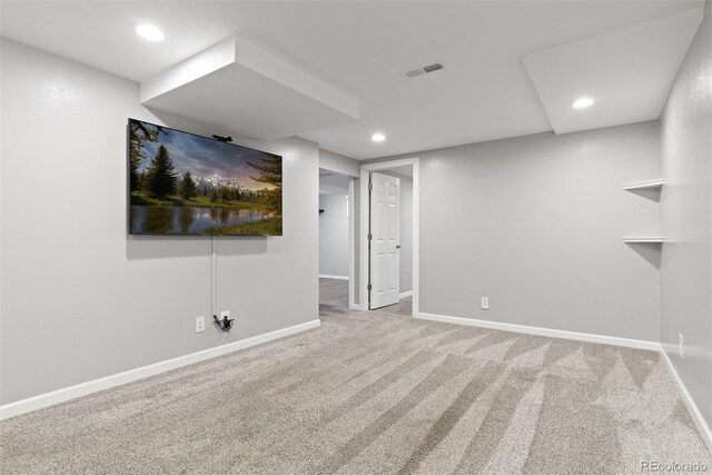 finished basement featuring carpet floors, baseboards, and visible vents