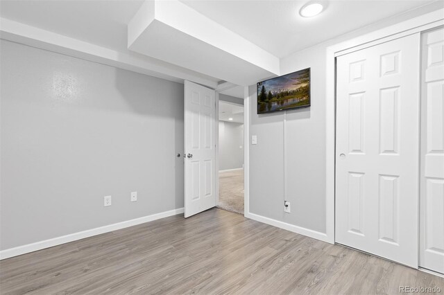 unfurnished bedroom with baseboards and wood finished floors