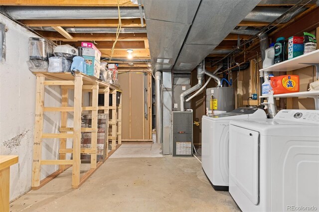 unfinished basement with washing machine and clothes dryer, heating unit, and gas water heater