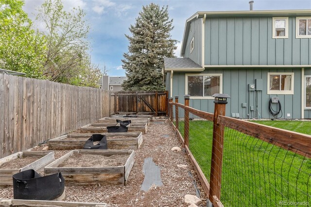 view of yard featuring a fenced backyard and a garden