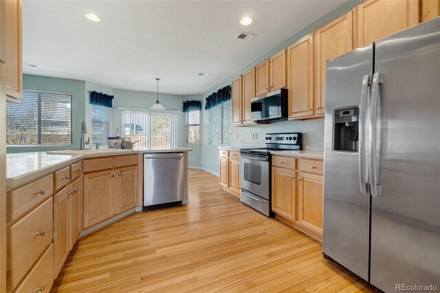 275 Gold Maple St, Brighton, CO 80601 - kitchen featuring appliances with stainless steel finishes, light wood-style floors, light brown cabinets, light countertops, and recessed lighting
