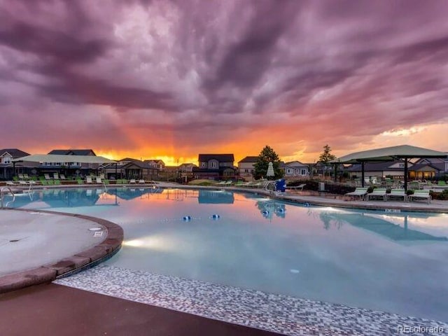 275 Gold Maple St, Brighton, CO 80601 - pool at dusk featuring a community pool and a patio area