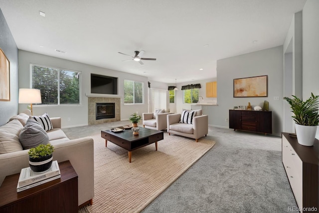 275 Gold Maple St, Brighton, CO 80601 - living room featuring ceiling fan, a tile fireplace, light colored carpet, and baseboards