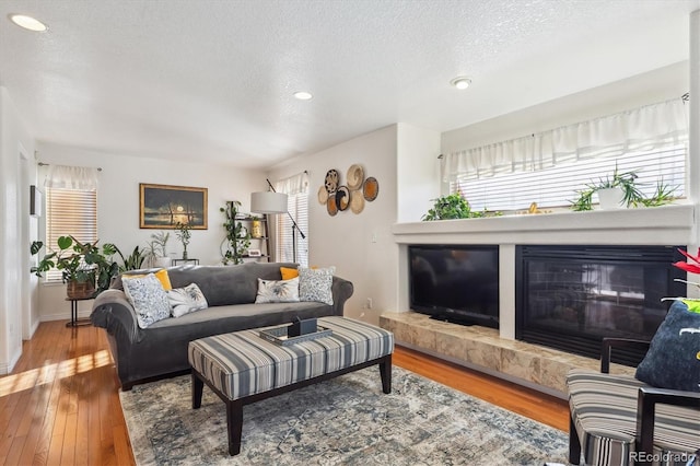 living room with wood-type flooring and a textured ceiling