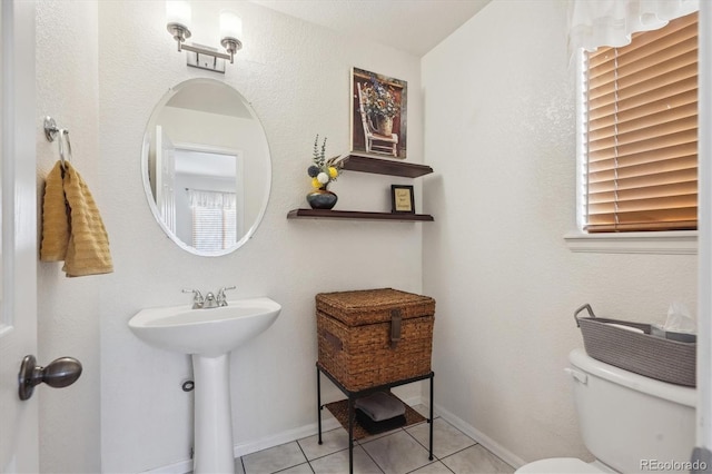 bathroom with toilet and tile patterned floors