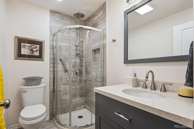 bathroom with vanity, toilet, and walk in shower