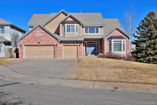 view of front of house with driveway, brick siding, a tile roof, an attached garage, and a front yard