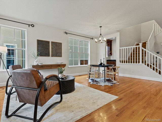 2880 Emporia Ct, Denver, CO 80238 - living area with wood finished floors, a chandelier, and baseboards