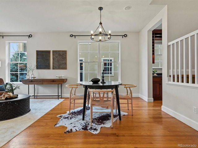 2880 Emporia Ct, Denver, CO 80238 - dining space with a chandelier, light wood-style floors, and baseboards