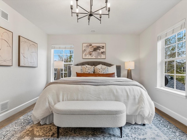 2880 Emporia Ct, Denver, CO 80238 - bedroom featuring baseboards, multiple windows, and a chandelier