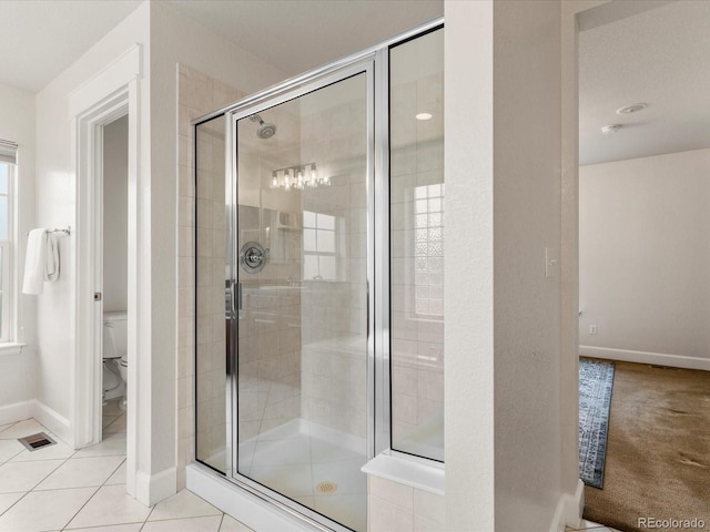 2880 Emporia Ct, Denver, CO 80238 - bathroom featuring a shower stall, toilet, baseboards, and tile patterned flooring