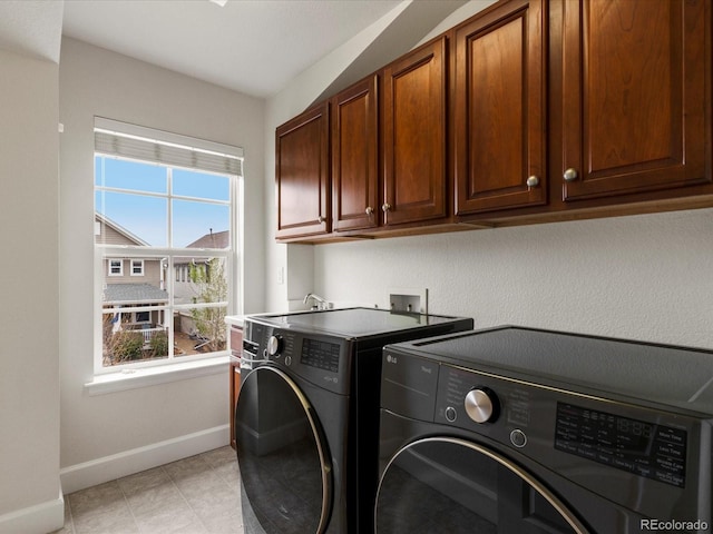 2880 Emporia Ct, Denver, CO 80238 - laundry area with washer and clothes dryer, baseboards, cabinet space, and plenty of natural light