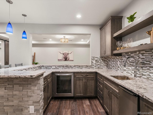 2880 Emporia Ct, Denver, CO 80238 - kitchen featuring a sink, dishwashing machine, dark brown cabinets, dark wood-type flooring, and light stone counters