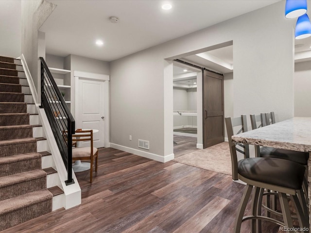 2880 Emporia Ct, Denver, CO 80238 - foyer entrance with stairway, dark wood-style flooring, baseboards, recessed lighting, and a barn door