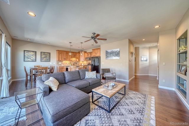 living area featuring recessed lighting, baseboards, dark wood finished floors, and ceiling fan