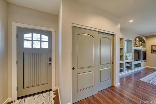 foyer entrance featuring recessed lighting, baseboards, and wood finished floors