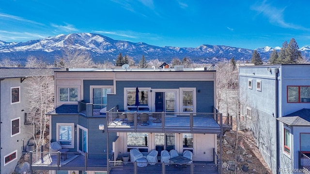 view of front of house featuring a mountain view and a balcony