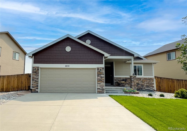 craftsman-style house with a garage and a front lawn