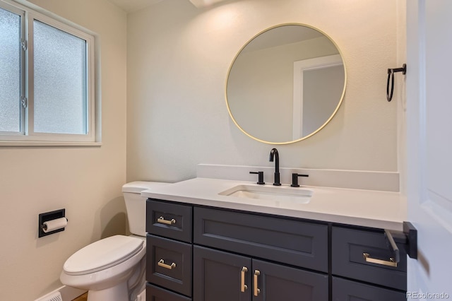 bathroom featuring toilet and vanity