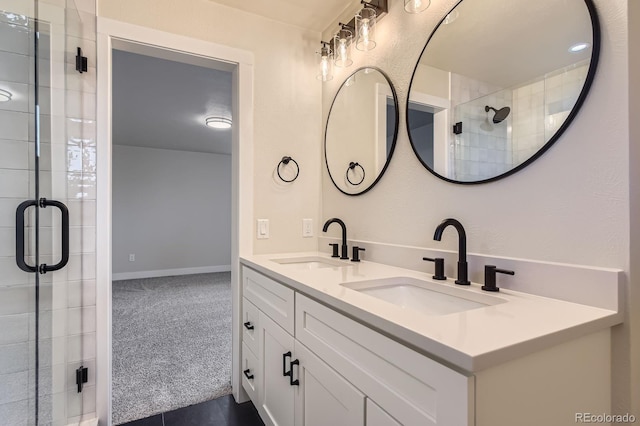 bathroom with double vanity, a stall shower, and a sink