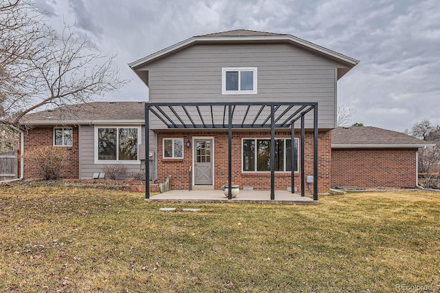 rear view of property featuring a patio, brick siding, a lawn, and a pergola