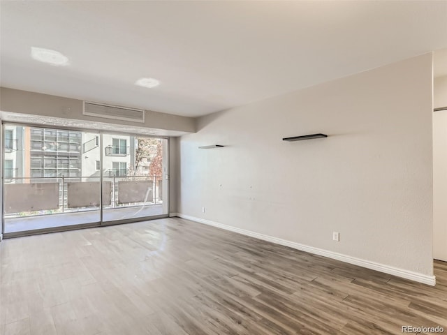 spare room featuring wood-type flooring