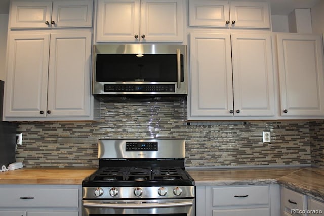 kitchen featuring decorative backsplash, stainless steel appliances, and white cabinetry