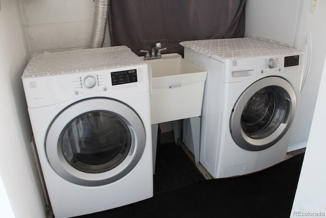 clothes washing area featuring independent washer and dryer