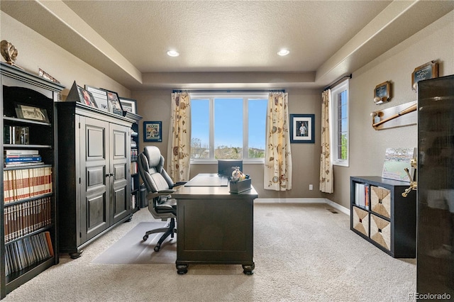 office featuring light carpet, a raised ceiling, a textured ceiling, recessed lighting, and baseboards