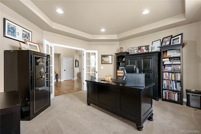 office space with light colored carpet, french doors, recessed lighting, baseboards, and a tray ceiling