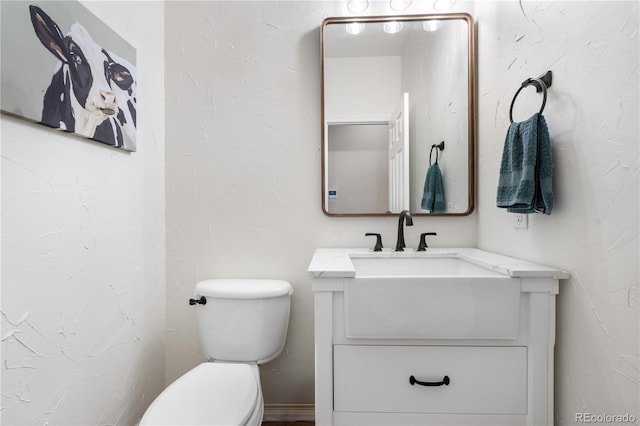 half bathroom featuring toilet and vanity