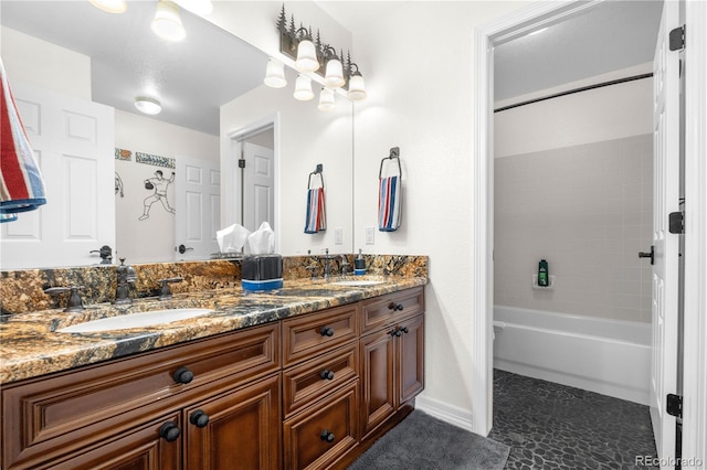 bathroom featuring double vanity, baseboards, tub / shower combination, and a sink