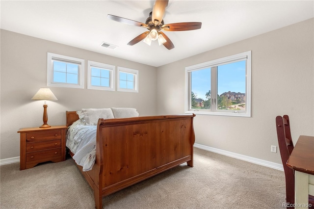 bedroom with baseboards, a ceiling fan, light colored carpet, and visible vents
