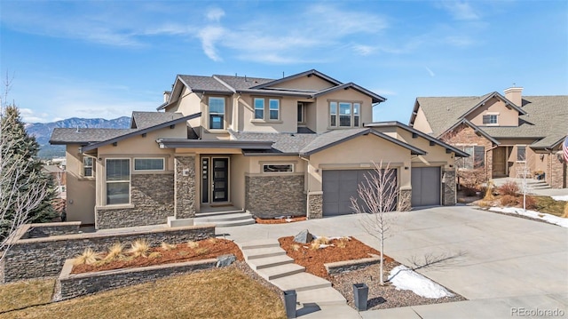 view of front of property featuring driveway, stone siding, a garage, and stucco siding